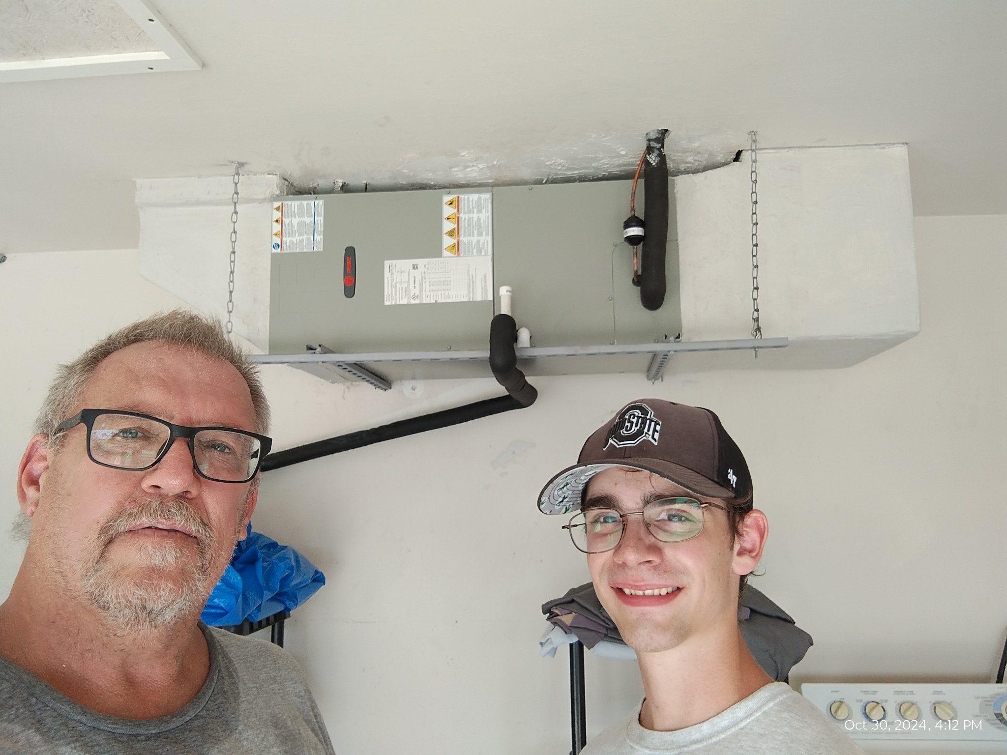 Joe and Garrison in front of a newly installed air handler